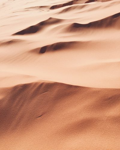 realistic photo of sand dunes in the desert, close up, warm colors, beautiful, high resolution, canon eos r5 --ar 51:64