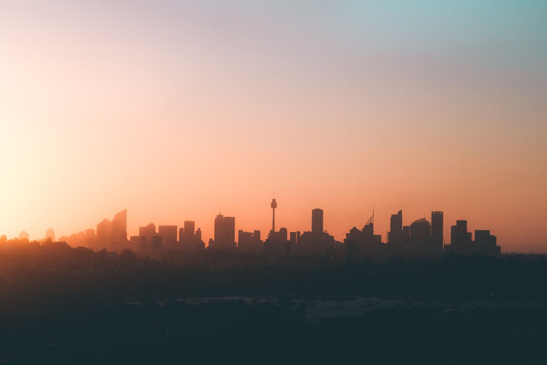 photograph of the Sydney skyline at sunrise, minimalist in pastel colours, in the style of unsplash photography. –ar 128:85