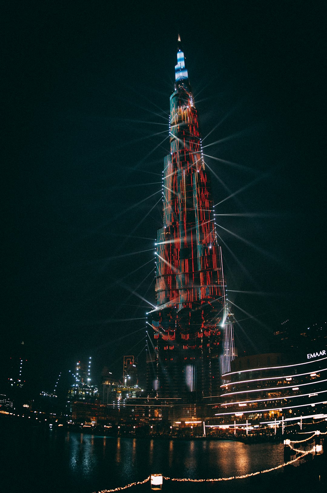 The Burj Khalifa covered in a red and white light show with projection mapping on it at night time. A divine moment shot in the style of Canon EOS R5. –ar 85:128