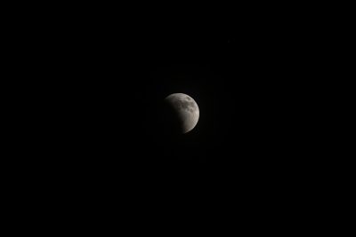 photograph of the moon in black sky, full eclipse, camera flash, cinematic, raw, film grain, lens flares, shot on sony alpha A7 III --ar 128:85