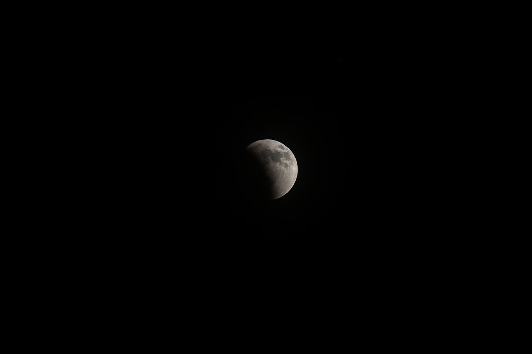 photograph of the moon in black sky, full eclipse, camera flash, cinematic, raw, film grain, lens flares, shot on sony alpha A7 III –ar 128:85