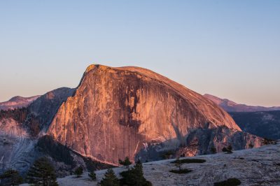 Photo of Half Dome in Yosemite National Park, golden hour, clear sky, taken with a Nikon D850 DSLR with an aperture of f/4 and ISO setting of 270 for the best balance between detail and sharpness. --ar 128:85