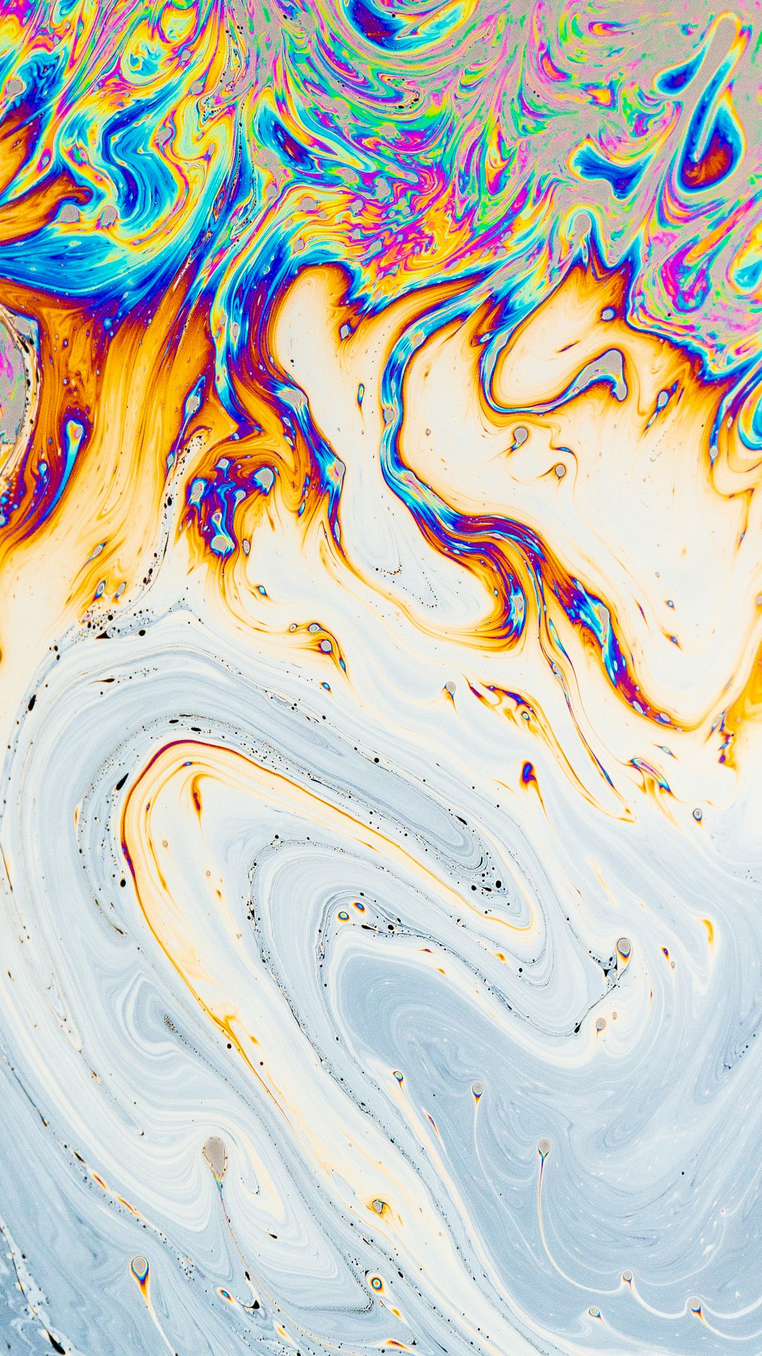 A closeup of swirling colors in liquid soap, creating an abstract pattern with blues and yellows, reminiscent of the colorful patterns found on marble surfaces. The background is white to highlight these intricate designs. –ar 9:16