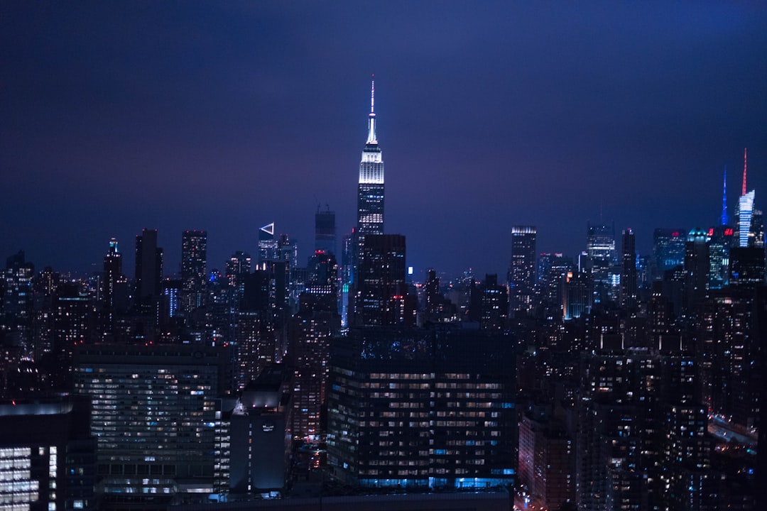 Night view of New York skyline with the Empire State Building in the center, in the style of Canon EOS R5. –ar 128:85