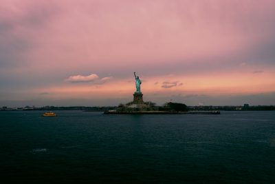 cinematic photo of the Statue of Liberty in New York City, pink sky, wide shot, boat on the sea, in the style of [Ansel Adams](https://goo.gl/search?artist%20Ansel%20Adams). --ar 128:85