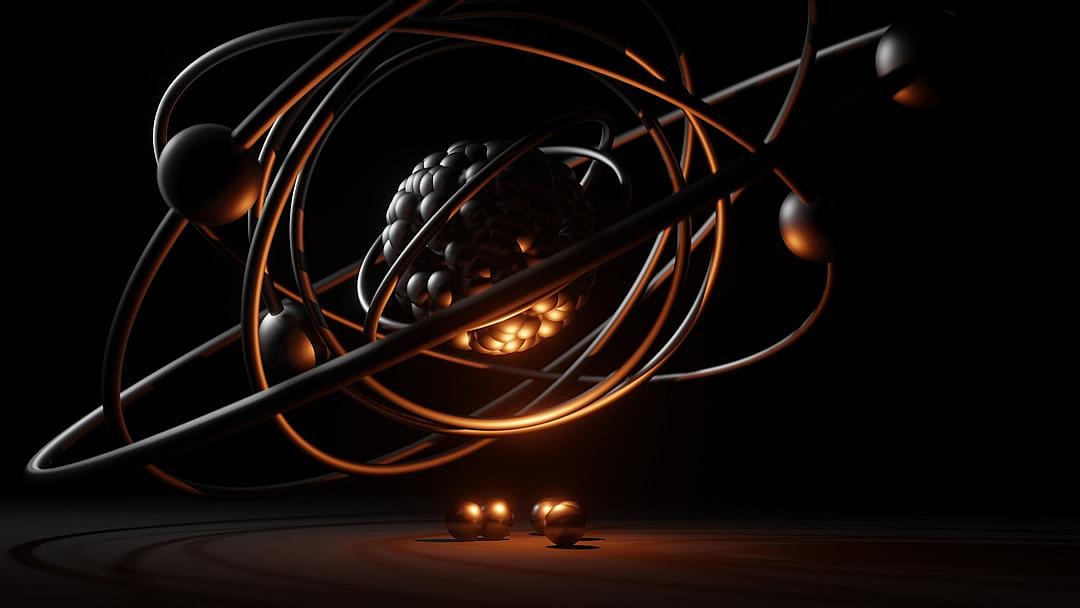 A black background with an orange glowing atom model, creating a dark and mysterious atmosphere. The chrome wire forms the shape of a ball in front of it, while two other balls float beside them. In between these three objects is another smaller piece, resembling futuristic shapes, adding depth and visual interest to the composition. This combination creates a visually stunning and captivating scene in the style of minimal editing of the original text.