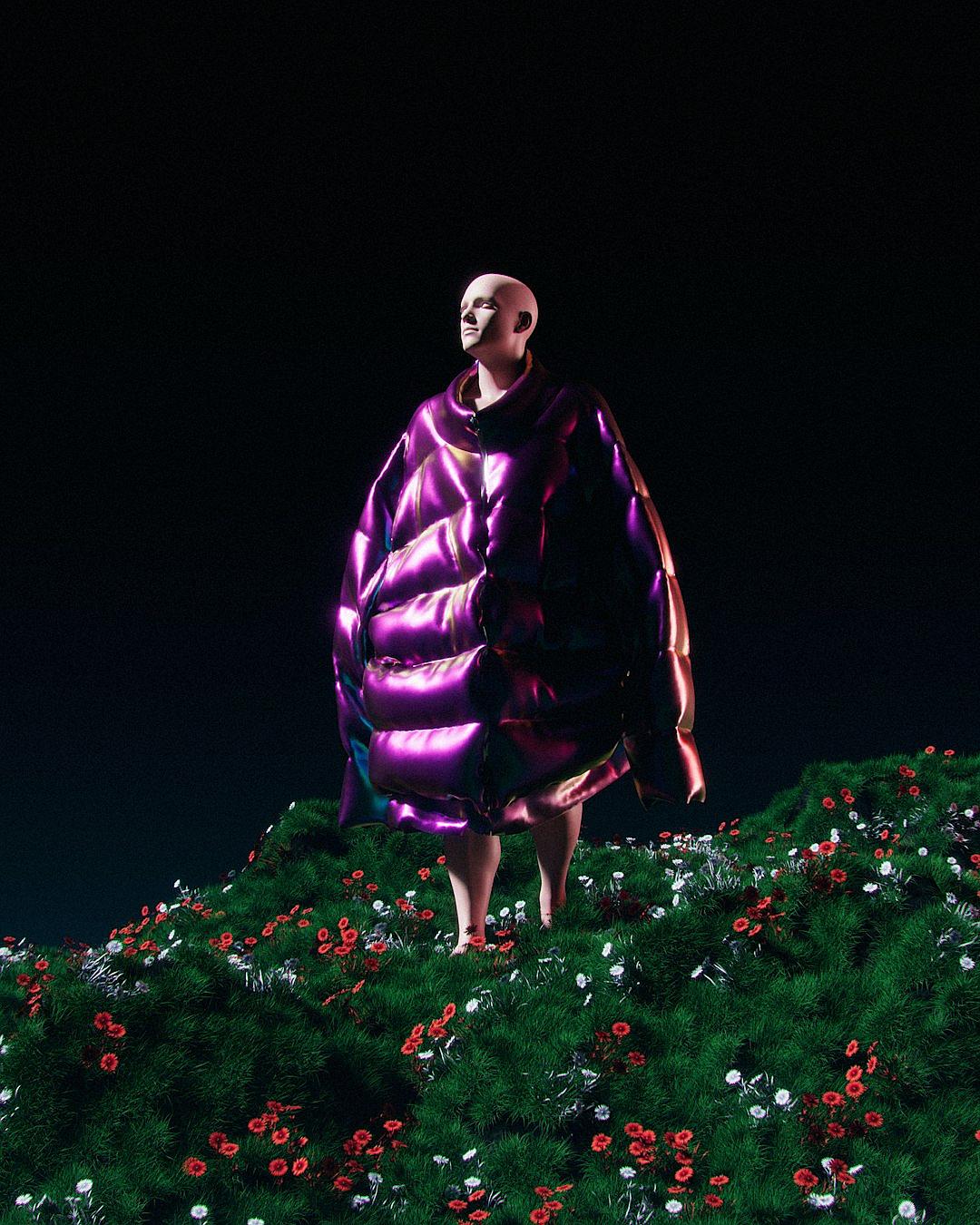 A surreal fashion photo of an androgynous man with no hair wearing oversized inflatable made from purple silk, standing on top of green grass covered in flowers against black background. The dress is puffy like marshmallows, and the colors of his outfit are vibrant and striking. He stands tall as if he’s ready to walk down stairs or something. It feels dreamy and magical. There’s lots of space around him, making it look ethereal.