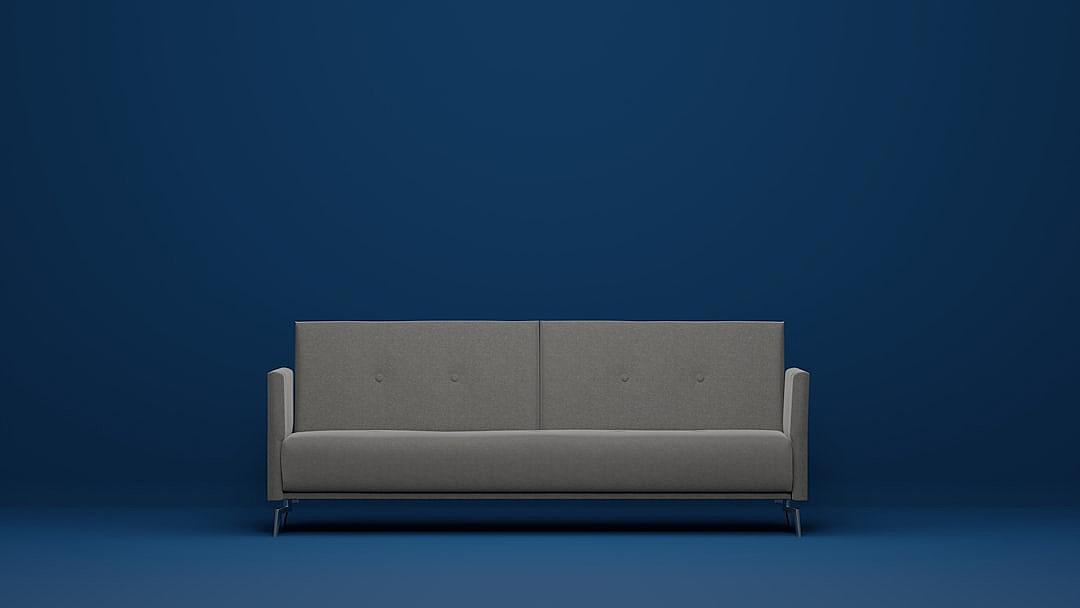 Minimalist gray sofa on blue background, simple and elegant, product photography in the style of studio lighting, high resolution, ultra realistic