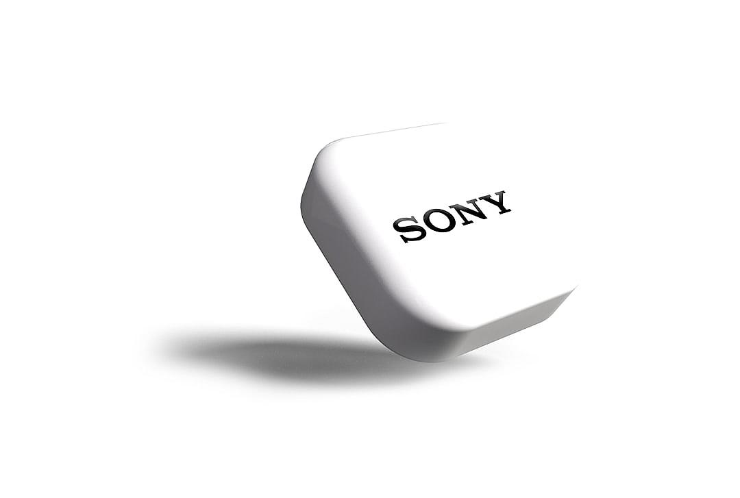 A small white soft rubber cube with the word “sony” on it, on an all white background, in high resolution, in the style of realistic.