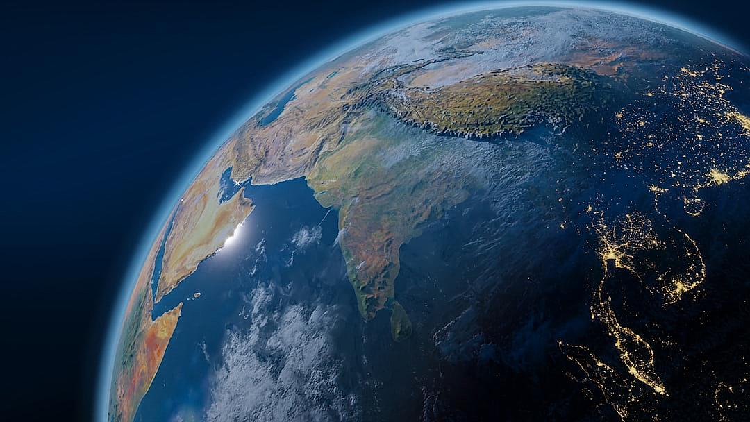 A closeup view of Earth from space highlights India’s position in South Asia, emphasizing its significance as an emerging tech power and growing economic hub. With twilight lighting, details like city lights in India are showcased against a dark blue sky, in the style of Sasha.