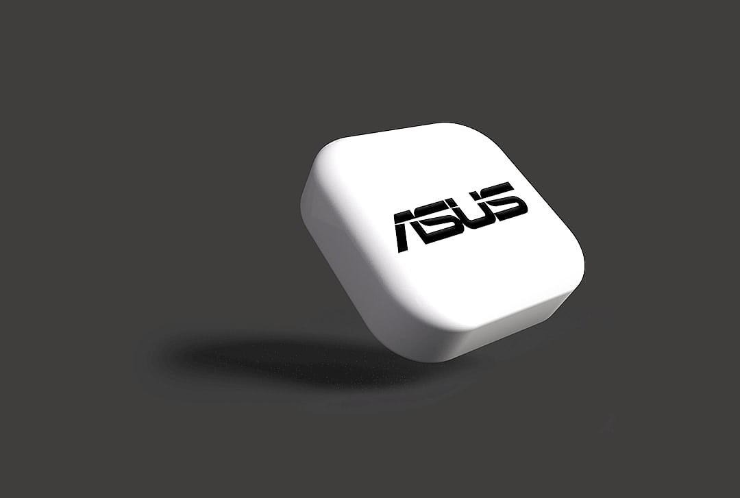 3D render of a white rounded square with an Asus logo on it, floating in the air against a solid grey background, in the minimalistic style with black shadows and without reflections or a visible light source, featuring a white color palette and high contrast.