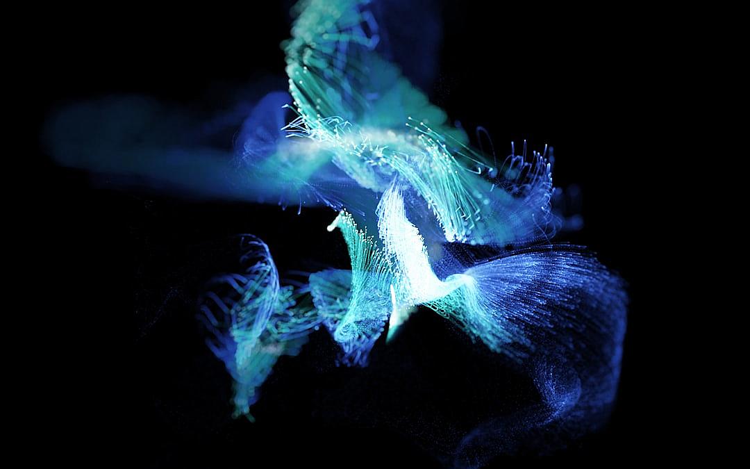 A bioluminescent blue and green creature made of glowing fibers floating in pitch black space, in the style of photograph.