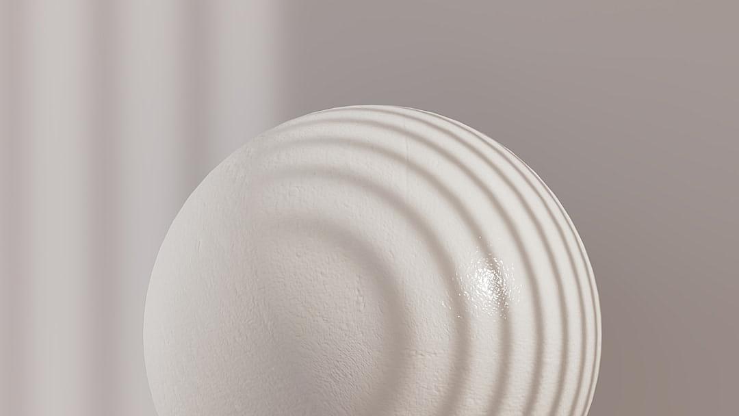 A closeup of the white sphere, with soft lighting and a neutral background. The surface has subtle ridges that give it an elegant appearance. In front is a small circle of light casting gentle shadows on its edge. This scene captures simplicity in design while highlighting textures and shapes in the style of its creator.