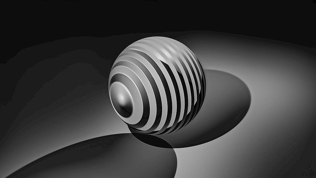 A black and white photograph of an optical illusion, a sphere with a striped pattern on it, casting shadows that give the impression of three-dimensional movement. The sphere is placed in front of a flat background, creating strong contrast between light and shadow. The stripes have varying thickness to add depth to the scene. This photo was taken in the style of Peter Pichler using a Canon EOS camera with Kodak TriX film stock.