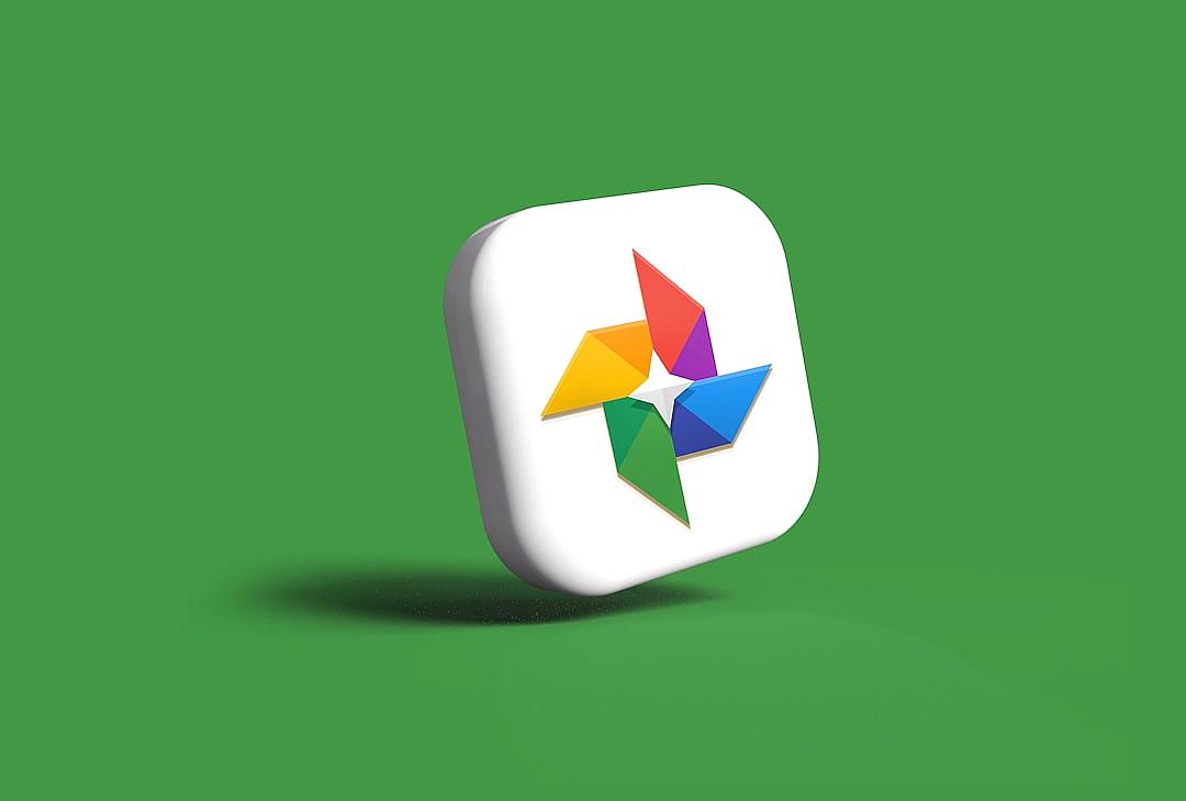 A refined and professional app icon logo for a photography album, with a white square with rounded corners in the style of Apple design, featuring a colorful windmill on a green background, and colorful origami-style paper cutouts.