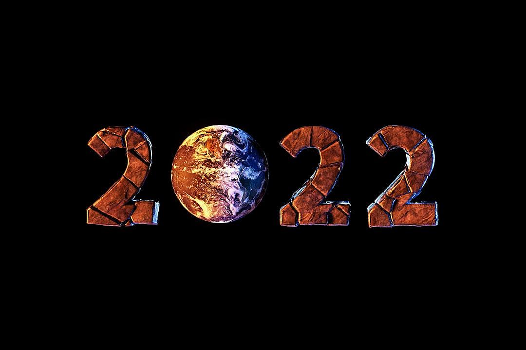 The numbers “2024” made of earth texture, with the planet Earth in between the letters. Black background.