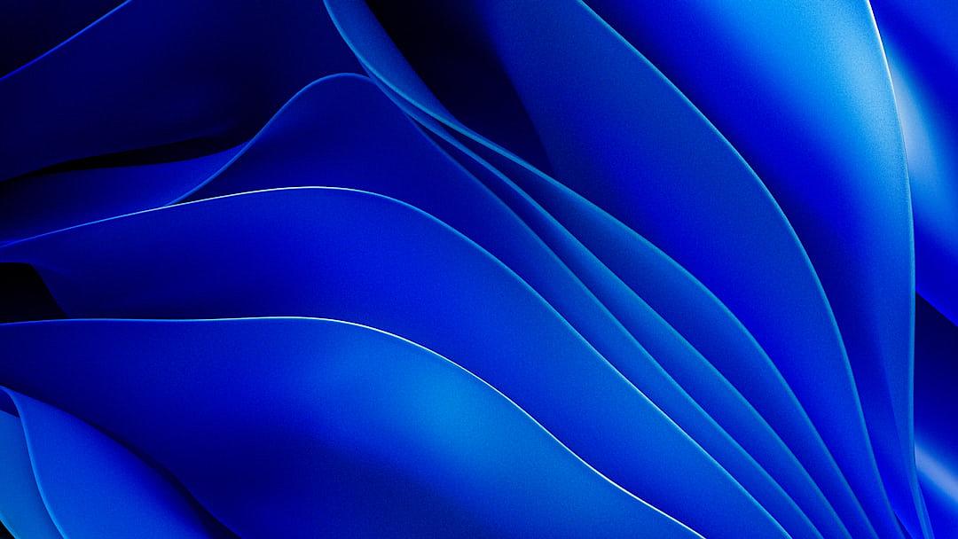 Blue abstract background with waves of paper in blue.