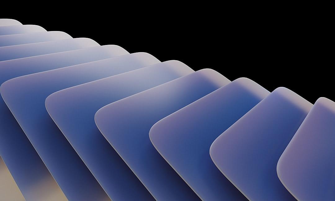 A series of blue curved paper sheets with subtle gradient colors, each representing different energy levels and varying in size from large to small, were arranged neatly on the left side against a black background. The soft lighting cast gentle shadows across their smooth surfaces, creating an abstract composition that evoked a sense of depth and movement. This design emphasized clean lines and modern aesthetics while conveying the idea of various energy structures within one system in the style of minimal editing.