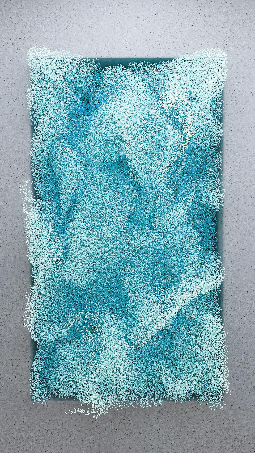 A rectangular piece of paper covered in fine blue sand, with a gray background. The particles form an abstract shape on the surface, creating a textured and dynamic appearance. This artwork is created using digital painting techniques to highlight intricate details. It presents the beauty of light blue powder particles, giving people a visual knotting feeling. The overall composition emphasizes balance between texture and colors in the style of digital painting.