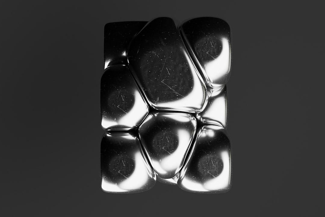 A black and white 3D render of an ice cube with rounded edges, arranged in the shape of three large cubes. The surface is glossy and reflective, creating an abstract design that resembles floating shapes or geometric forms. It’s set against a solid background to highlight its shiny texture and the contrast between lightness and heavy weight. This rendering creates a sense of depth through the use of shadows and highlights on the surface of each block, in the style of geometric forms.