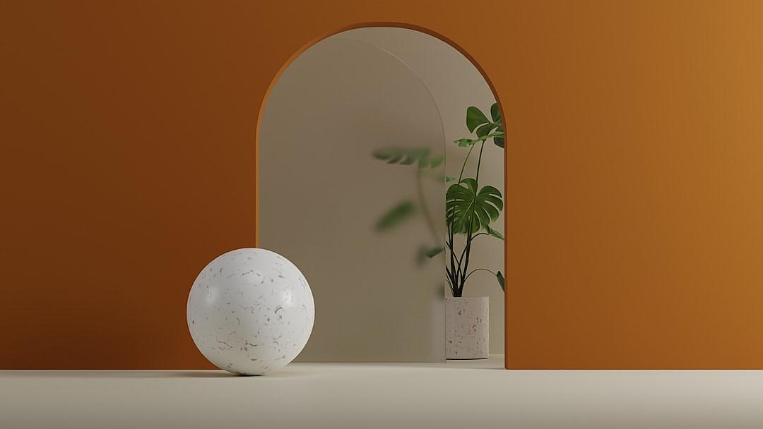 A minimalistic product shot features a white marble sphere with rounded edges on the left side, centered in frame against an orange wall. A plant is placed next to it and behind the archway is a mirror. The scene has a soft lighting effect. The overall aesthetic conveys tranquility and simplicity in the style of minimalism.