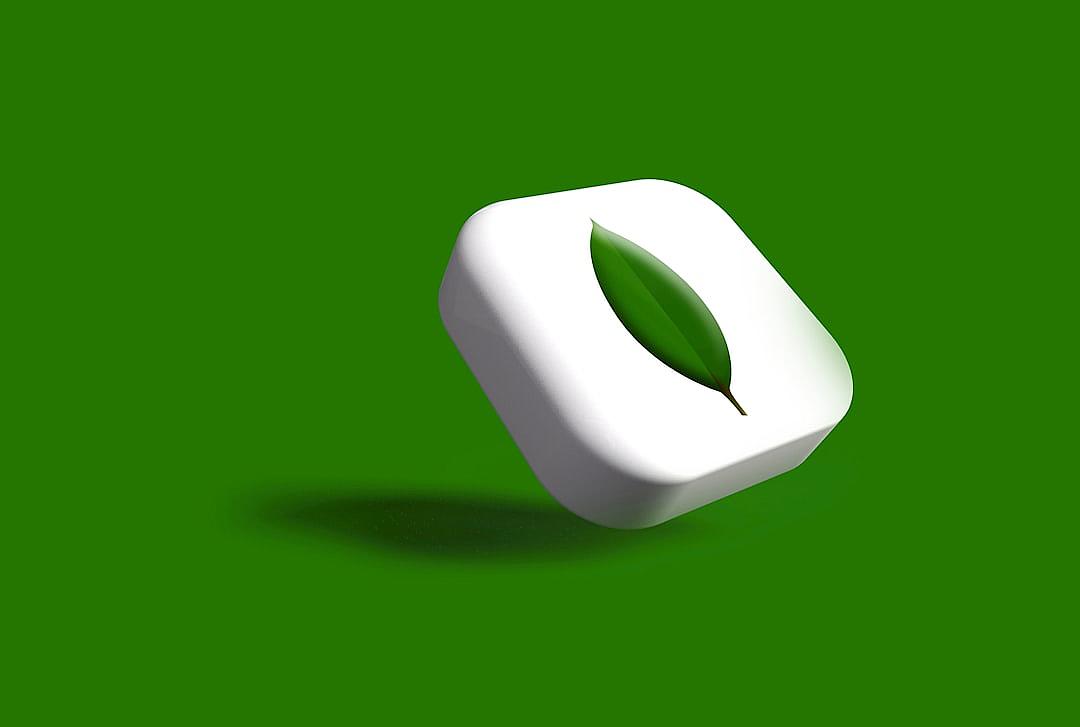 A white rounded square with an O-shaped leaf logo on it, rendered in a 3D style, with a green background, in the style of a cartoonish and cute design, with high resolution, photographed with professional lighting, using a wide-angle lens, with soft light, floating in the air.