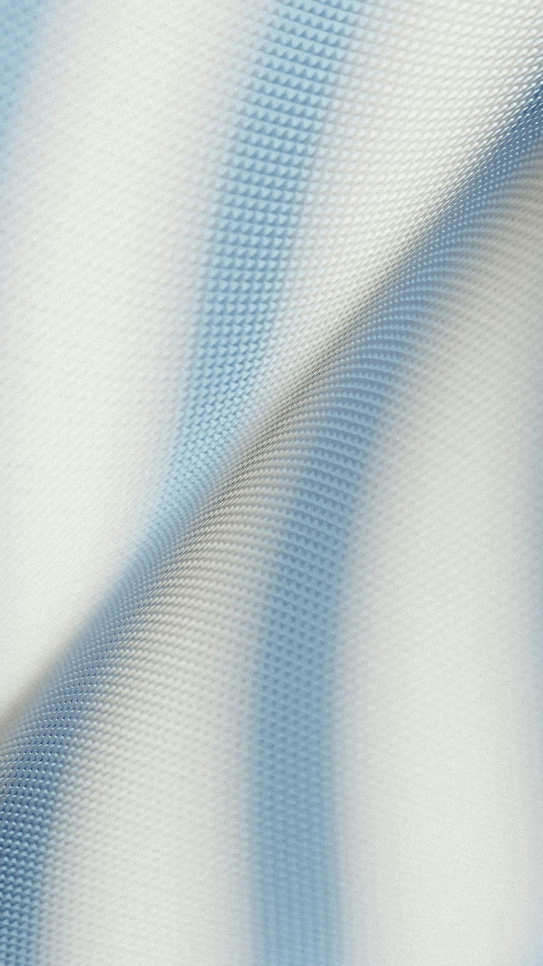 A closeup of the texture and structure of light blue, white fabric with a blurred background. The fabric is delicate and fine, creating an elegant atmosphere. It features soft lighting that highlights its gentle curves and intricate details in the style of an impressionist artist.