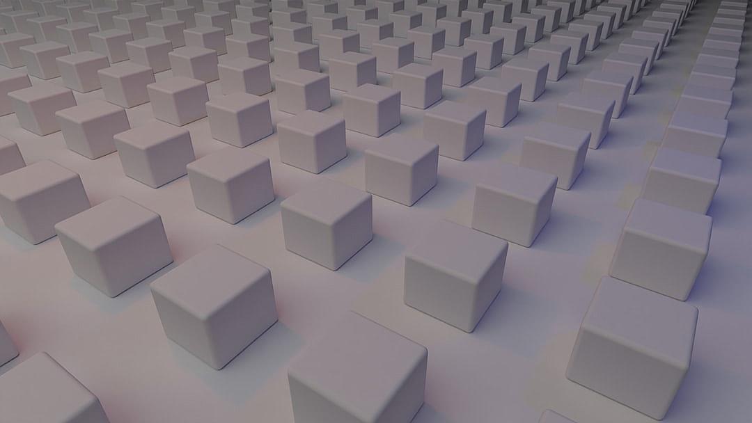 A large number of cubes arranged in rows and columns, all the same size, all white, all placed on an even surface, viewed from above. The background is plain with no objects or textures visible except for these cubes. There’s a soft lighting effect that gives each cube its own texture and highlights their details. This perspective adds depth to the scene by creating the illusion of many small cubes being spread out across the entire frame in the style of minimal editing.