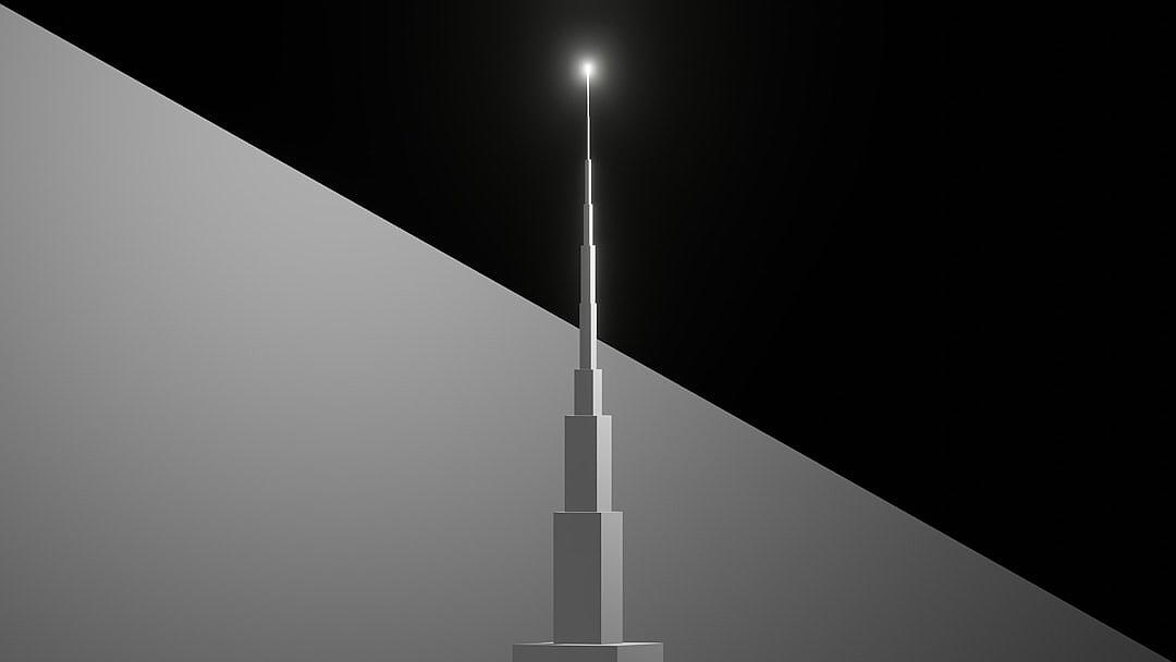 A minimalist composition of the Burj Khalifa, featuring its spire against an all-black background. The tower’s sleek design is accentuated by the stark contrast between light and shadow, creating depth in the monochromatic setting. This visual representation highlights the style of burdnight khal fizz, focusing on simplicity and elegance.