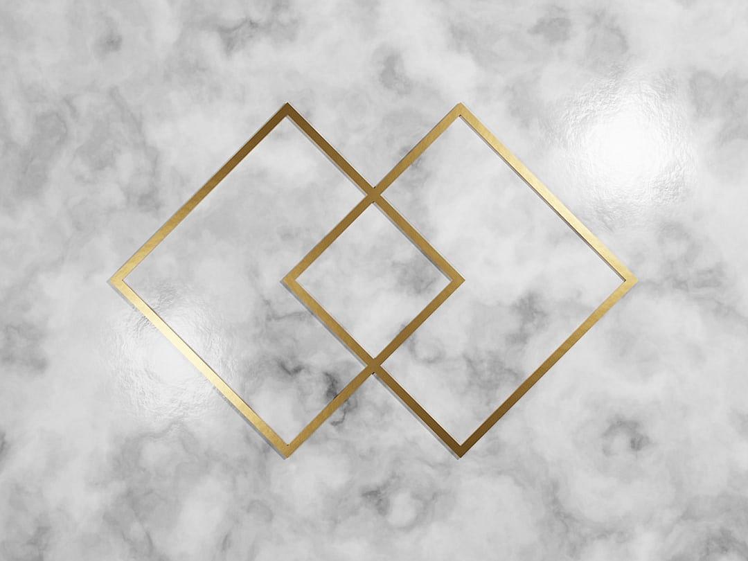 White marble background with two gold squares in the middle, vector illustration, minimalist style, symmetrical composition, top view, high resolution, professional photograph, studio lighting, no watermarks, natural light.