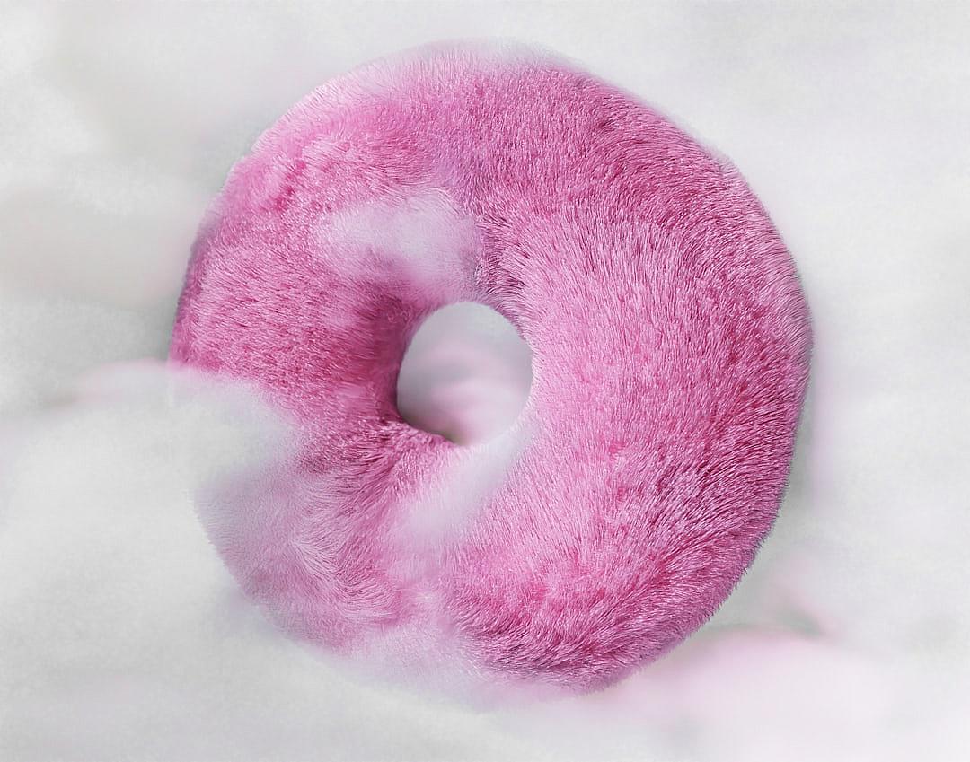 Pink furry donut-shaped, fluffy plush textured, white background, top view, product photography, studio lighting, soft shadows, high resolution, high detail, sharp focus, in the style of hyperrealism