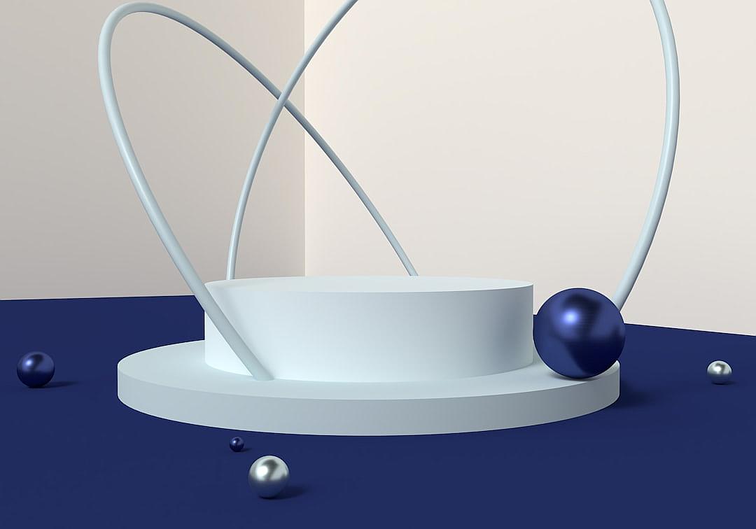 A minimalistic podium with two blue spheres and one white sphere, set against an empty background. The composition is centered on the platform, creating negative space around it. There is a thin wire forming a spiral pattern in front of the plinth, adding depth to the scene. This style has elements reminiscent of modern art and digital illustration, focusing more on visual impact than realistic details or textures. The composition is in the style of modern art and digital illustration.