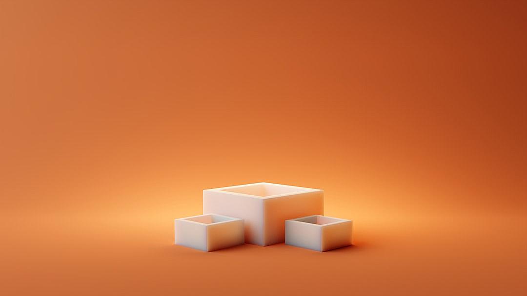 3D rendering of three white cubes on an orange background, in a minimalist style with a simple and clean composition. Soft lighting creates gentle shadows that accentuate the shapes. The overall warm and inviting color palette is perfect for showcasing products or featuring digital art pieces.