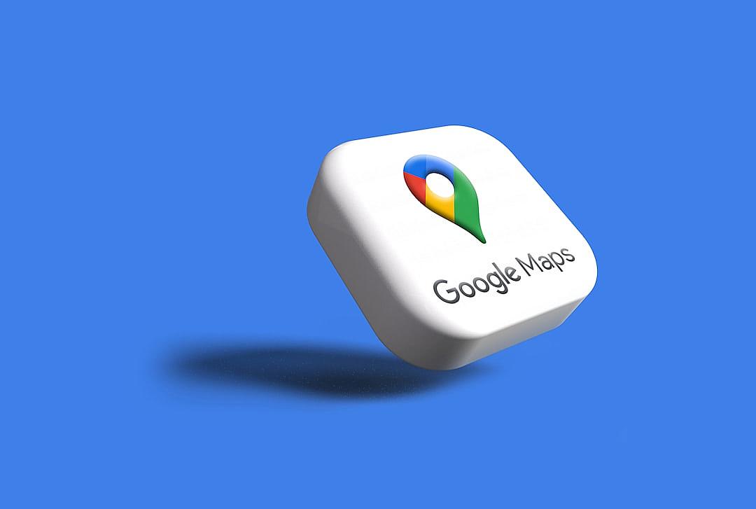 3D illustration of a white plastic icon with a Google Maps logo on a blue background, featuring a white color and green map pin, in the style of minimalistic sculptures and soft renderings. The illustration has a strong use of negative space and colorful animation stills reminiscent of the style of happycore.