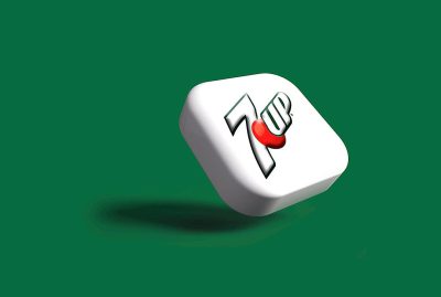 A white cube with the "7 Up" logo on it, floating in midair against a green background. The cubes have rounded edges and feature red highlights around their center point. There is no shadow cast by them, indicating they may be used for graphic design or branding purposes. This scene could represent an icon or symbol associated to whquareshaped drink from different angles, 3d render, cartoon style