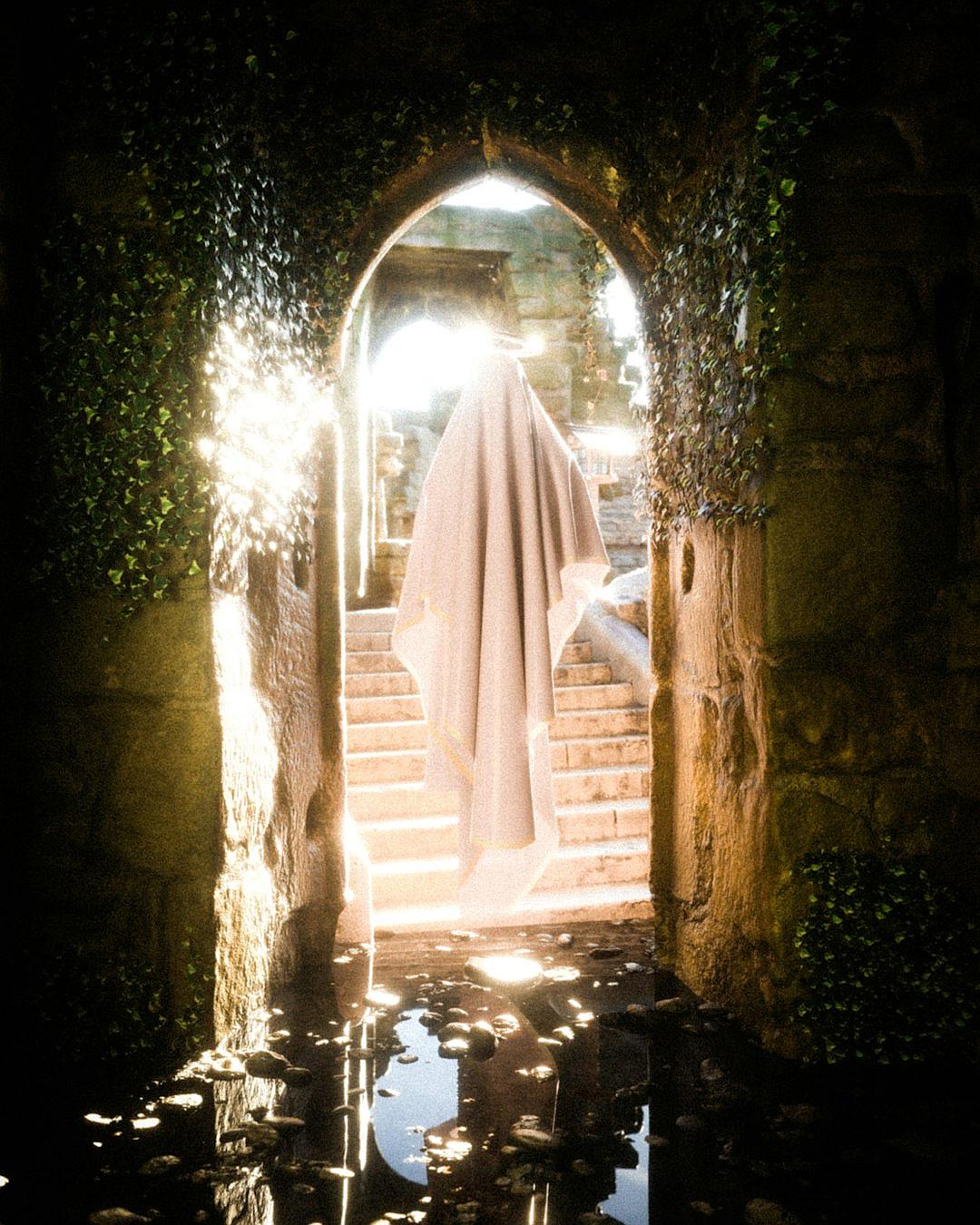 a photograph of an ethereal woman wearing white robes standing in the doorway to stone ruins covered with ivy, her cloak billows around her as she is pulled away by water from bottom of pool below stairs filled with light and reflection of sun rays