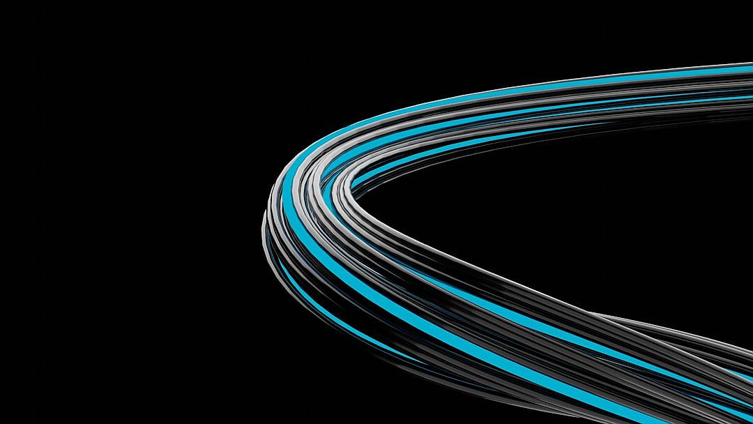 A curved, thin black and blue wire is shown on the right side of an allblack background. The wires appear to be made from steel or metal, with one gray line at its center that curves upwards into two smaller lines. There’s also another lightblue band around each edge of the central line. This design creates a sleek and modern look for your product, emphasizing speed in technology.