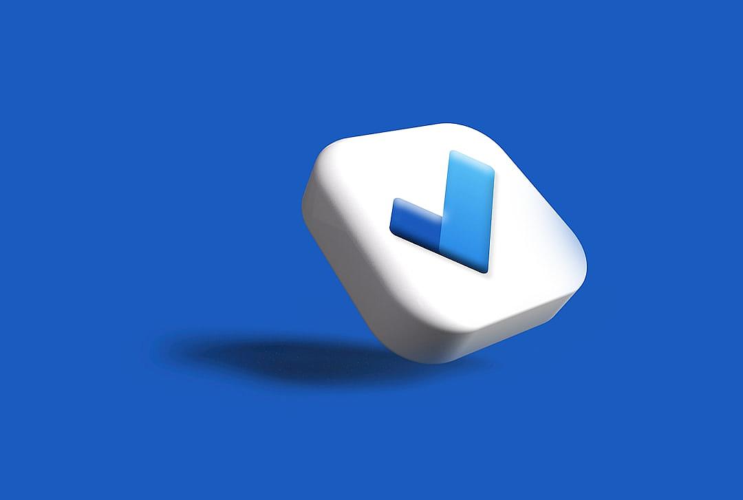 3D icon of a checkmark on a blue background, with a white and blue color scheme. A white square with rounded corners in an isometric view, with a minimalistic design and clean lines. The texture resembles matte plastic, with a high resolution render and sharp focus in a closeup shot. The style resembles in the style of a clean, minimal design.