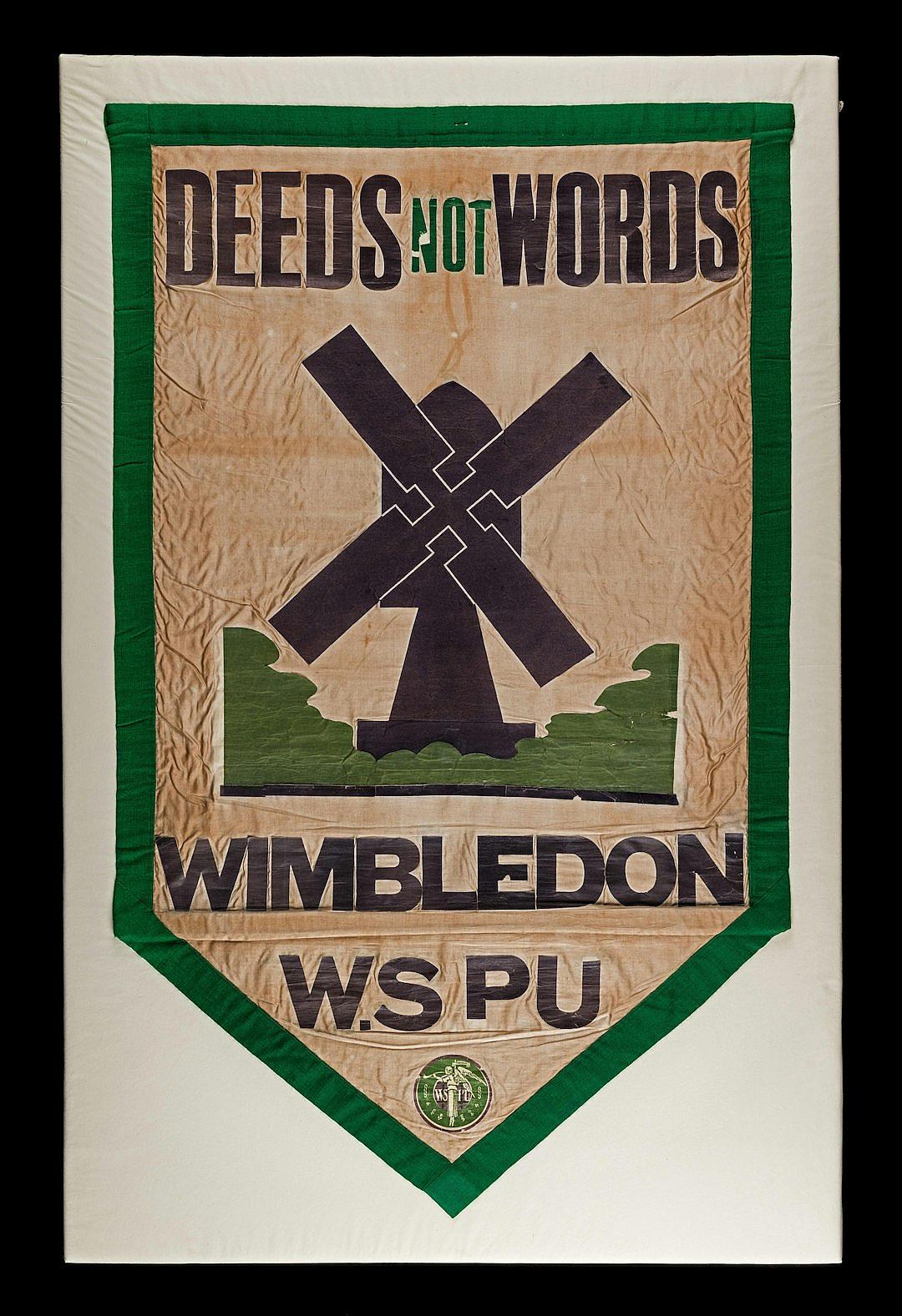 vintage cloth banner with windmill and text “DEEDS NOT Picks” in green, cream white background, vintage wמכרinswoodide football club emblem on the border of shield, black outline of logo with lettering “WDan shown as crossed by an scRet getDefault Football team name written in cursive letters under all that is saying Wiederod football player shown as cross hatching , “GOOD ENLabel shows logo “Battle “, style raw, png