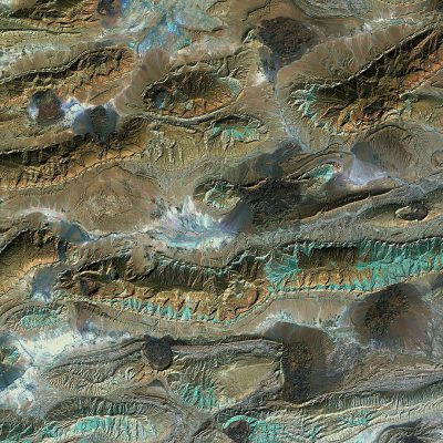 A satellite photo of the Terskaya Mountains in Samarkand, rugoudescent lines on top and bottom edges, earth tones with green blue accents, high resolution, topdown view, detailed texture