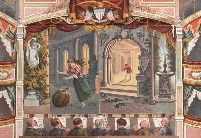 Victorian color illustration of an ornate theater stage with red curtains. A woman in a pumpkin and green striped long skirt is dancing on the floor in front of it, with people sitting below looking up at her. In the background is a large archway leading to a door that has a white man's head coming out from inside. Two marble statues of angels are watching all as one angel flies overhead. At the top left side of the scene is a small frame showing three faces. The frames around the entire illustration have colorful decorative borders.