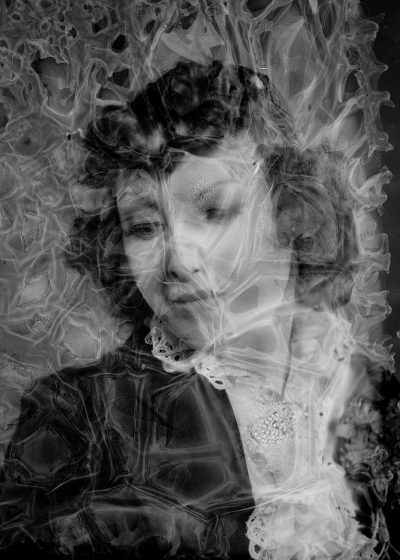 A black and white double exposure of hedy l highlighting the fluidity of light, softness of fabric, and movement in portraiture. In her portrait, she is wearing an elegant dress with lace details. The background features swirling patterns reminiscent of smoke or water, adding depth to the overall composition. Her expression reflects serenity as if lost within her thoughts.