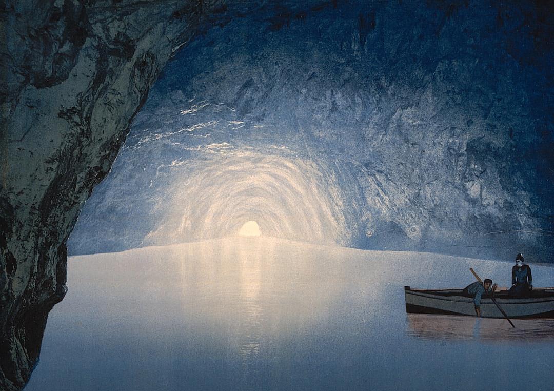 The boat is in the cave, there is an opening at one end of it and you can see into another rocky tunnel with light coming from above. A man sits on his boat rowing towards that entrance, in the style of [Maxfield Parrish](https://goo.gl/search?artist%20Maxfield%20Parrish), dreamy illustration, blue white silver colors.