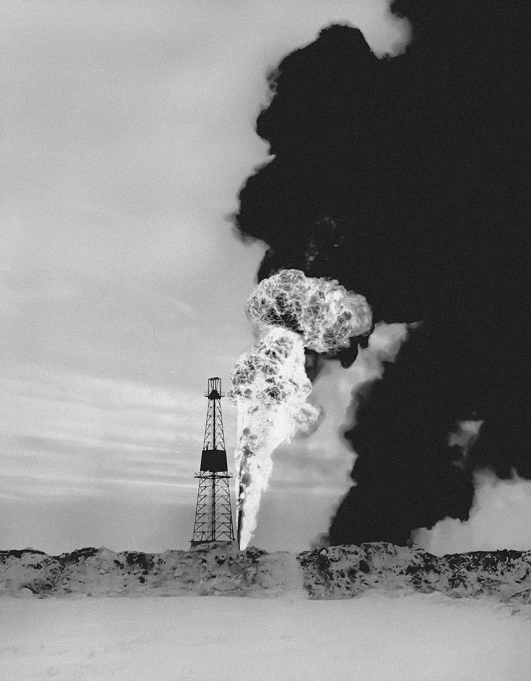 A black and white photograph of an oil rig in the distance, smoke rising from its chimney, set against arctic snow-covered ground, captured in the style of [Man Ray](https://goo.gl/search?artist%20Man%20Ray) with his distinctive photographic style, evoking mystery and magic. The composition is symmetrical, with a focus on contrast between light and dark areas, creating strong visual impact. Shot at eye level using Kodak TriX film to emphasize details like texture and color.