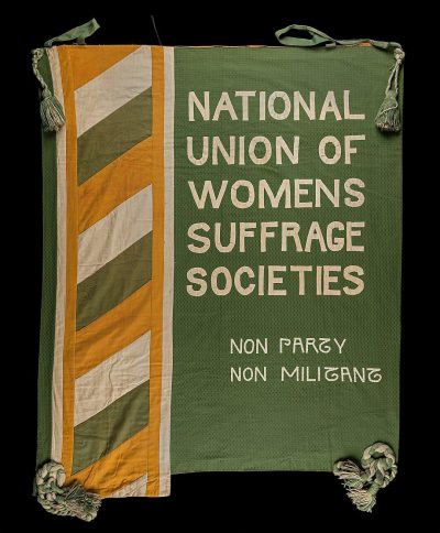 A green banner with white and yellow stripes, featuring the words "national union of women's luggage" on it in large letters, with smaller text saying "non partoving society". The flag is set against an all black background, creating a stark contrast that emphasizes its boldness and simplicity. It stands out as a symbol for a woman's rights or social justice movement.