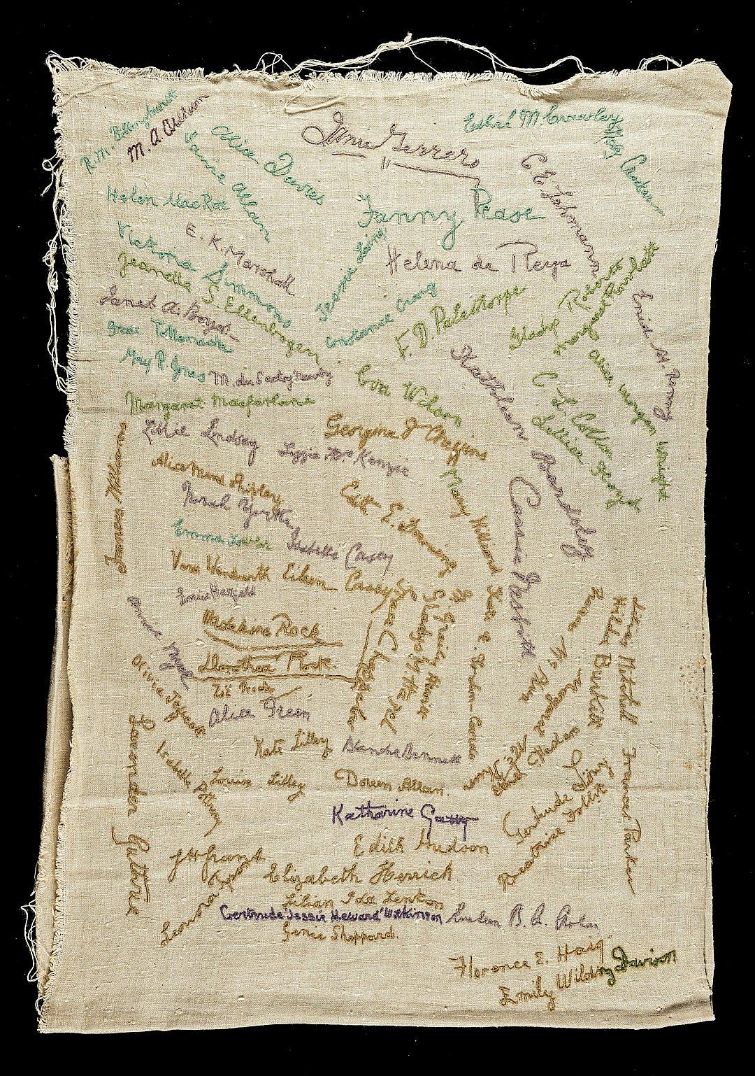 A linen handfocus embroidered piece of cloth with many different people’s name and signature on it, green ink text,