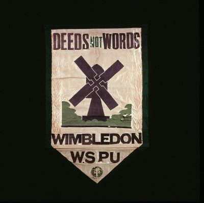 vintage embroidered banner with windmill and text "DEEDS Rena not Nearly autistic". With the letters Wminsuggeston in purple, on black background. In the style of wellsian flag art from the movie Q the live action version of yellowstone series. A green emblem below says "W� arrangemnts" The emblems have a small white cross at its center.