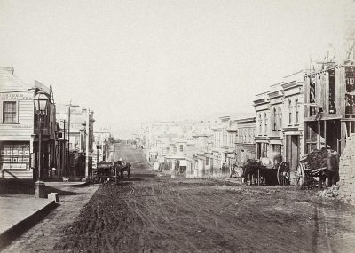 An old photograph of an empty street in San Francisco, with horse-drawn carriages and buildings being built along the sides of it, dirt roads, Victorian era architecture, no cars or people visible, taken with a 20mm lens at f/4, in the style of no specific artist.