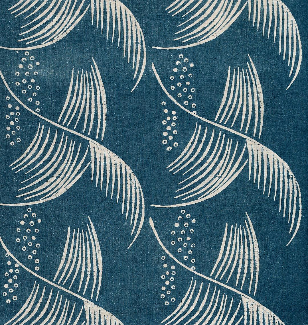 linocut block print of blue fabric with white design of wavy palm leaves and bubbles, simple pattern