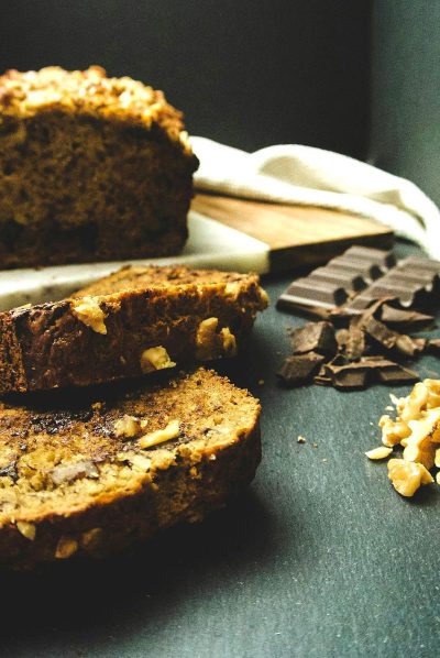 food photography of banana bread with dark chocolate and walnuts, sliced on table